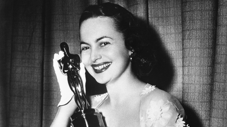 Olivia de Havilland holding 1950 Best Actress Academy Award Oscar for 'The Heiress'