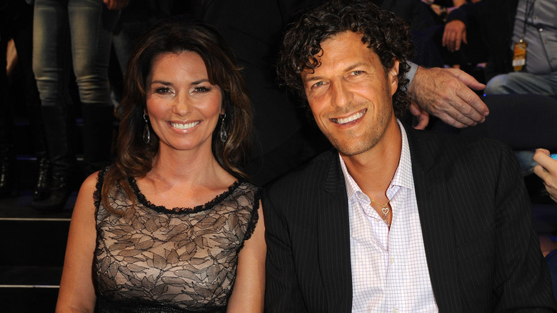 Shania Twain and husband Frédéric Thiébaud seated next to each other at an event.