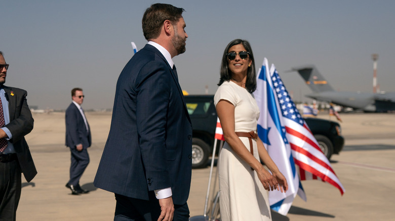 Usha and JD Vance walking towards their airplane.