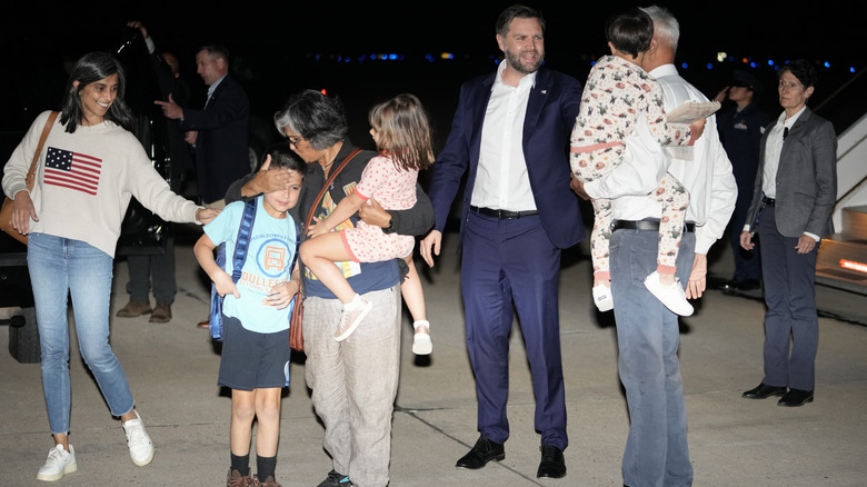 Usha and JD Vance are greeted by her parents on a tarmac.