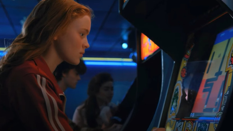 Sadie Sink playing arcade game