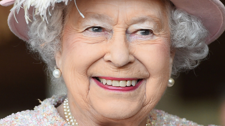 Queen Elizabeth smiling in pink