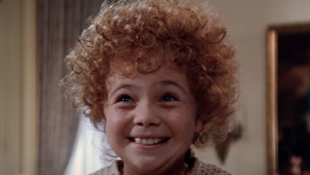 Aileen Quinn smiling as Annie