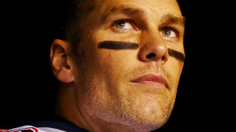 Tom Brady poses before a football game