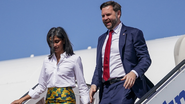 Usha and JD Vance step off an airplane together.