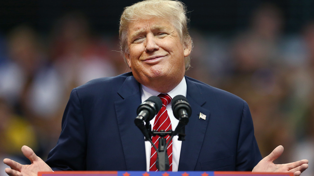 Donald Trump at podium, smirking
