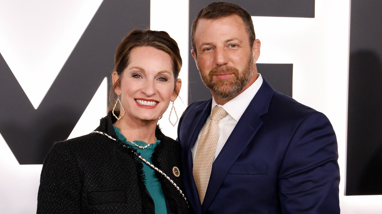 Markwayne Mullin and his wife smiling while posing at an event togethr