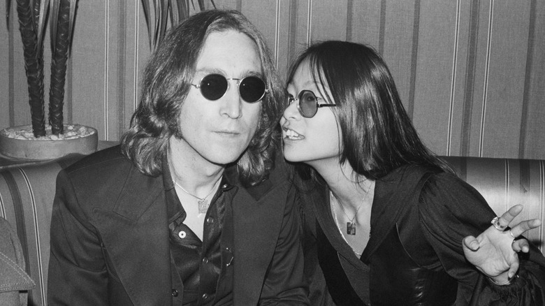 John Lennon and May Pang leaning into each other in photo