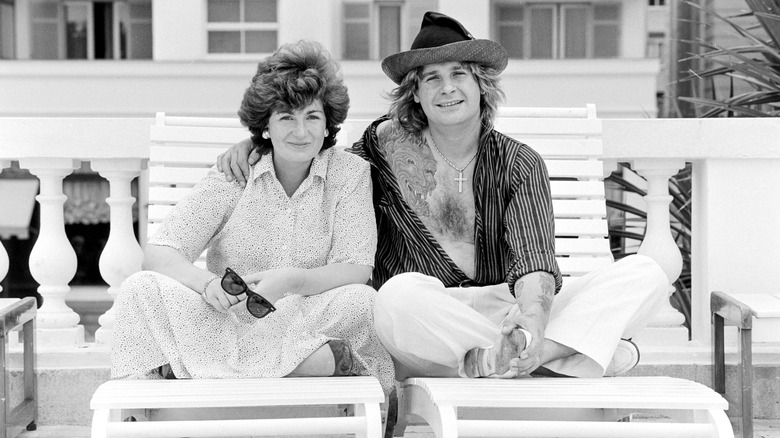 Sharon and Ozzy Osbourne sitting together on pool loungers in 1985