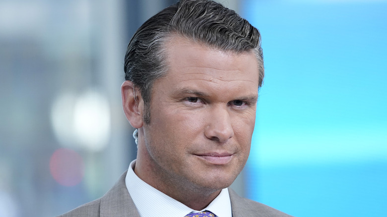 Pete Hegseth on air looking ahead with serious expression
