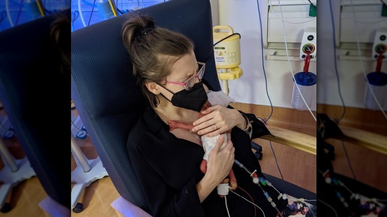 Eden Sher holds her premature baby in the NICU.