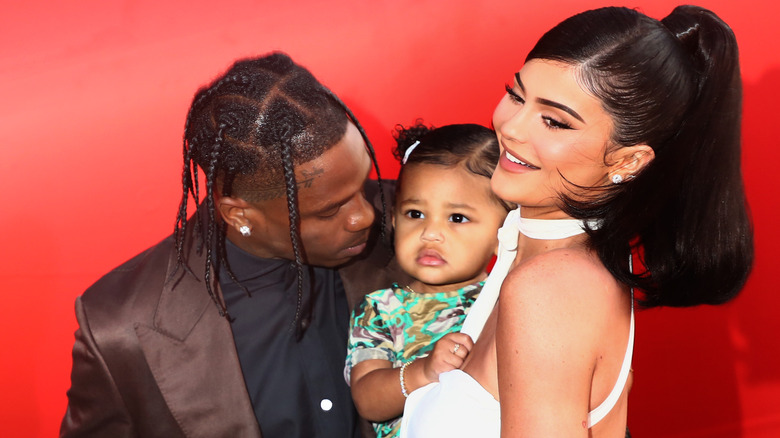 Kylie Jenner, Travis Scott, and Stormi pose