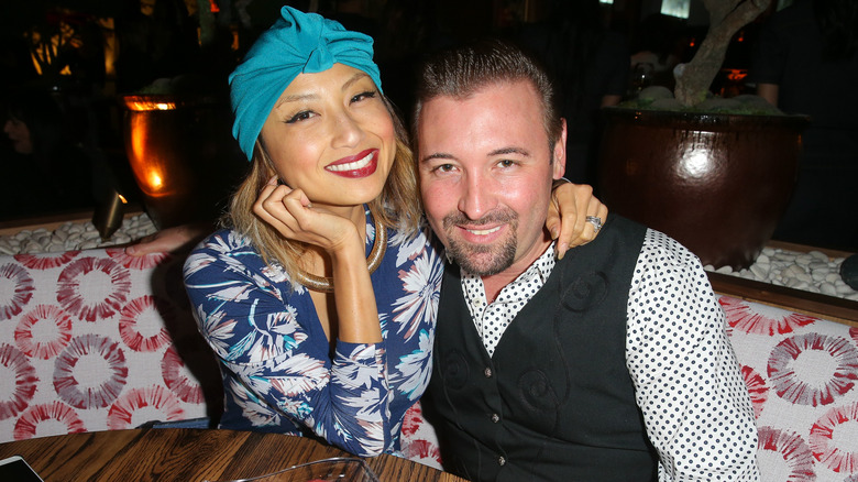 Jeannie Mai hugging Freddy Harteis, smiling