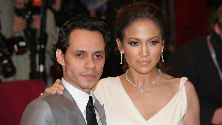 Jennifer Lopez's hand over Marc Anthony's shoulder