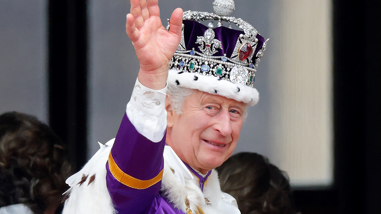 King Charles waving and wearing his crown during coronation ceremony