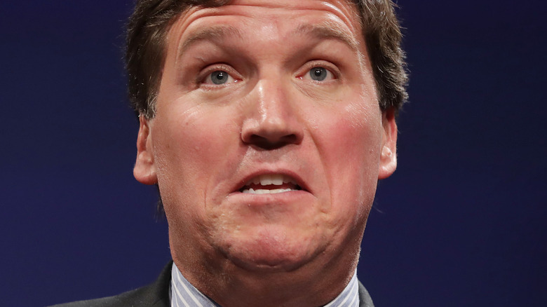 Tucker Carlson raised eyebrows double chin