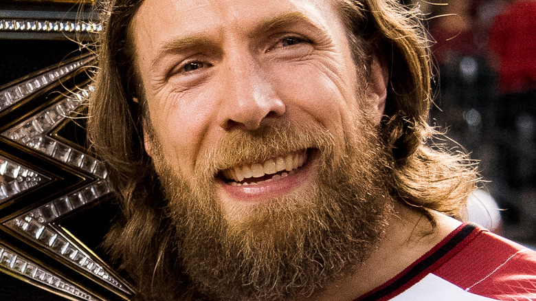 Daniel Bryan posing with his championship belt