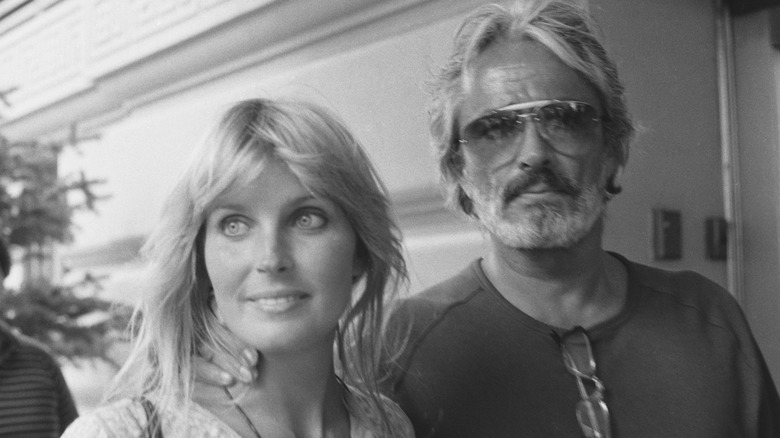 John Derek holds Bo Derek by the neck