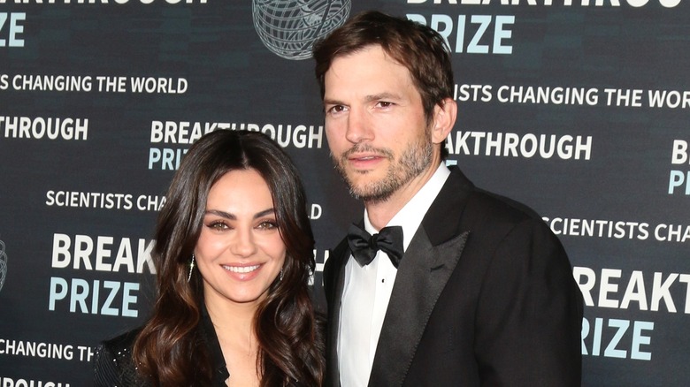 Mila Kunis and Ashton Kutcher posing