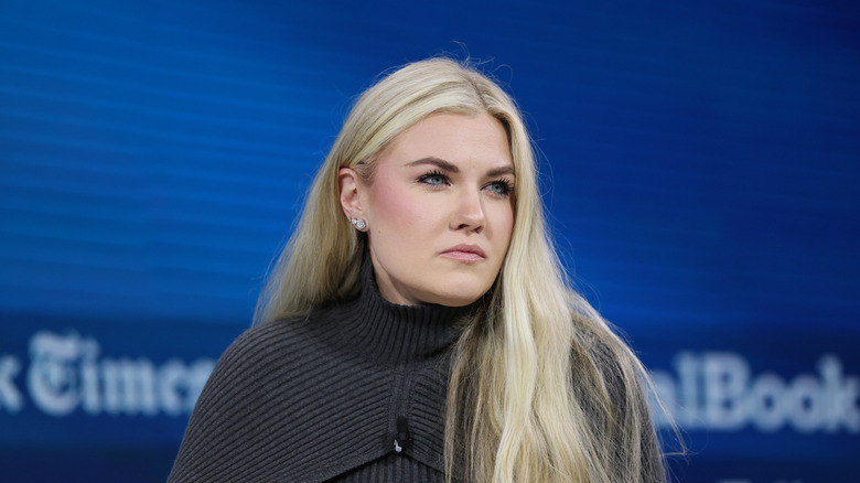 Erika Kirk listening intently during an interview in a dark grey sweater
