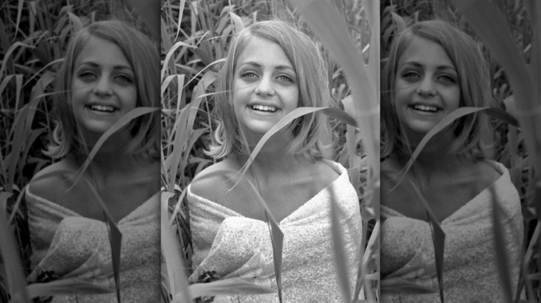 Goldie Hawn poses in wild grass in 1964