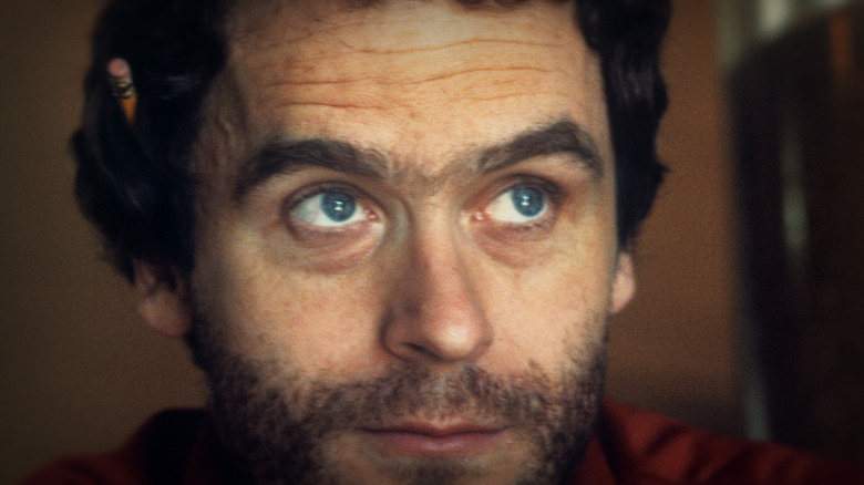 Ted Bundy looking up pencil in ear