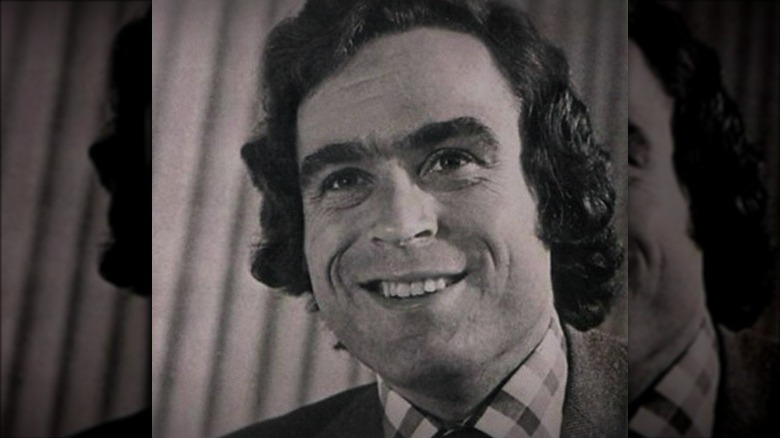 Ted Bundy smiling in a suit