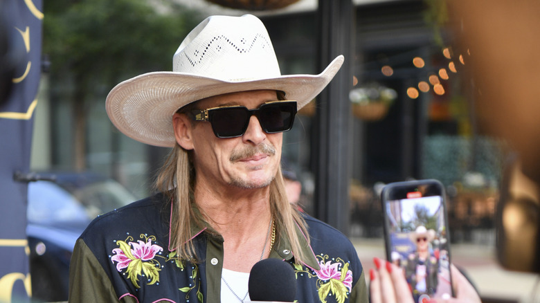 Kid Rock wearing a large white cowboy hat