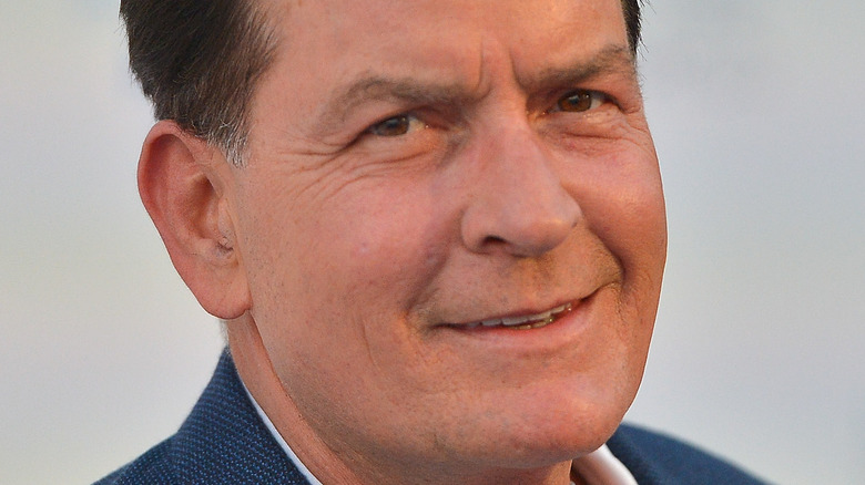 Charlie Sheen giving a half smile