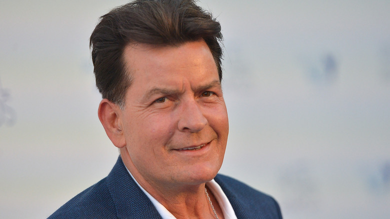 Charlie Sheen giving a half smile