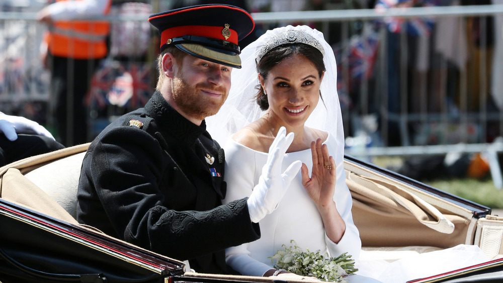 Prince Harry and Meghan Markle waving to the crowd at their wedding