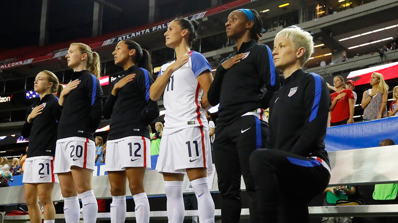 Megan Rapinoe kneeling before soccer match