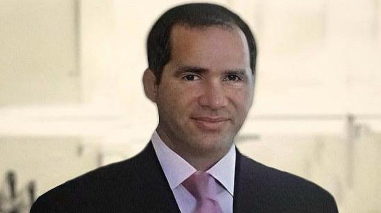 Billionaire Farkhad Akhmedov smiling in a suit