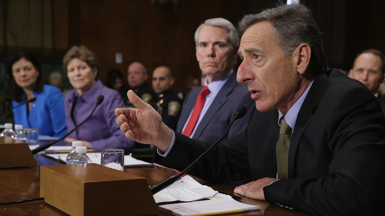 Vermont governor Peter Shumlin testifying in a room with others