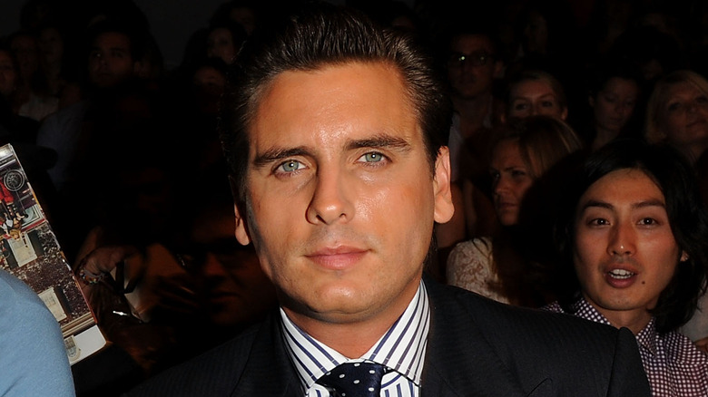 Scott Disick at a fashion show, posing