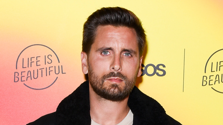 Scott Disick in a coat, looking at camera