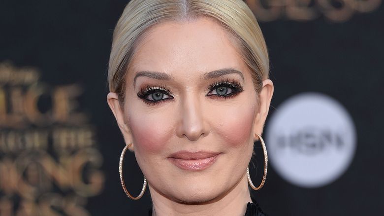 Erika Jayne hair slicked back with hoop earrings