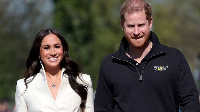 Meghan and Harry walk on running track