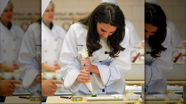 Kate Middleton wears a chef's coat and works in a kitchen