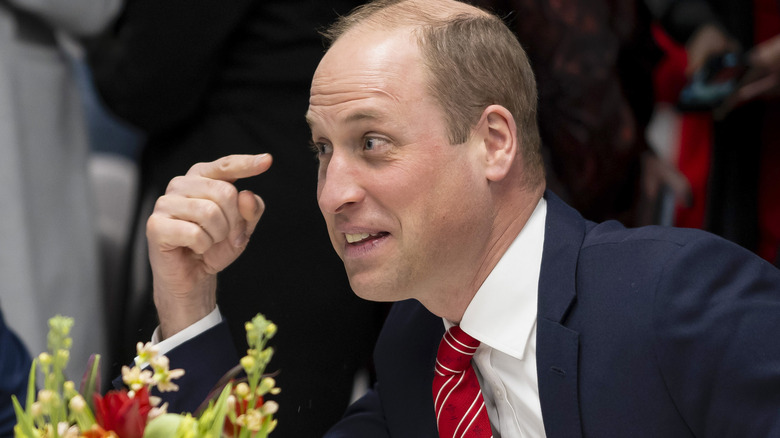Prince William points to his eyes 