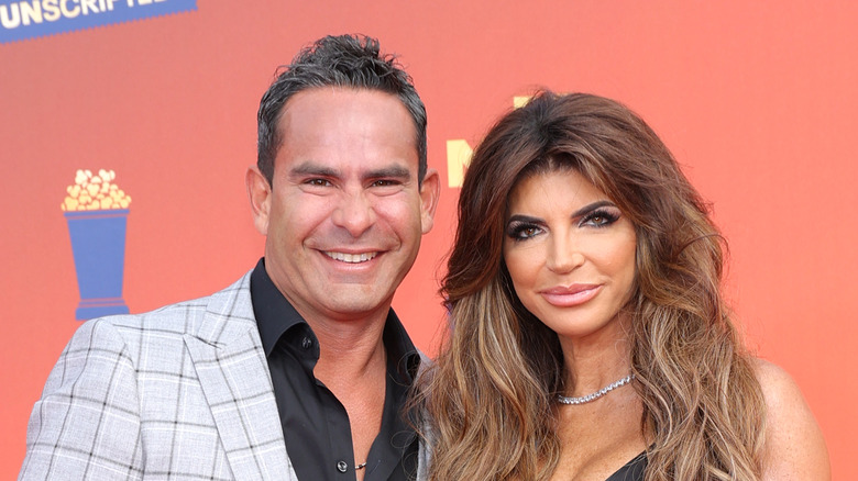 Louie Ruelas and Teresa Giudice orange background