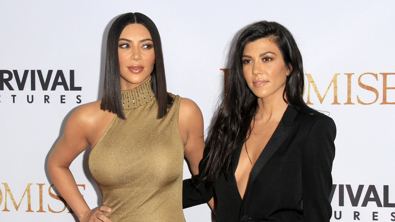 Kourtney and Kim Kardashian posing together
