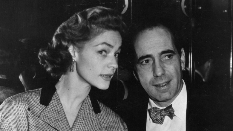 Humphrey Bogart and Lauren Bacall talking intimately