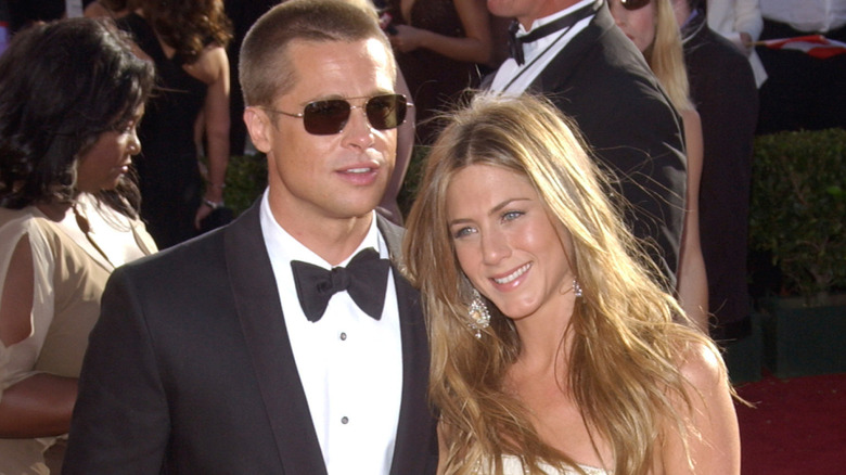 Brad Pitt and Jennifer Aniston posing on red carpet
