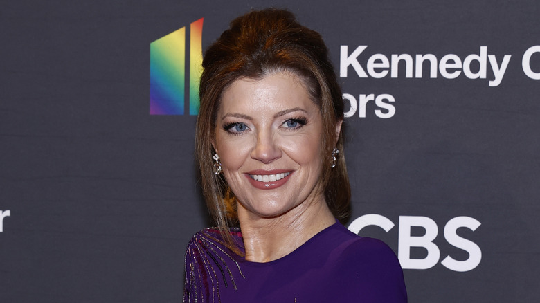 Norah O'Donnell posing in a purple dress.