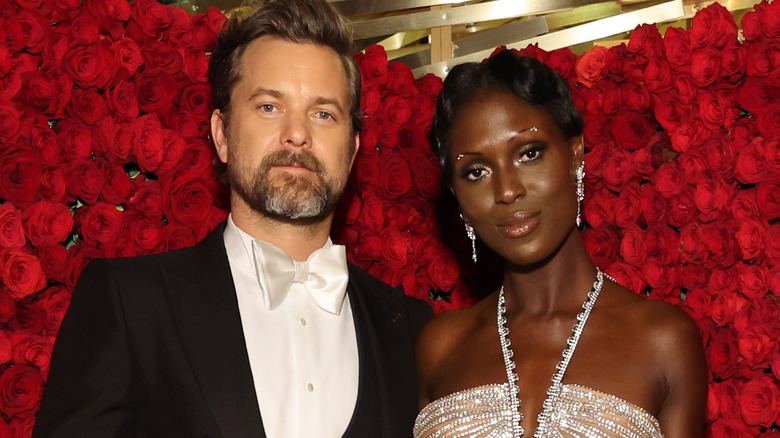 Joshua Jackson and Jodie Turner-Smith in front of roses