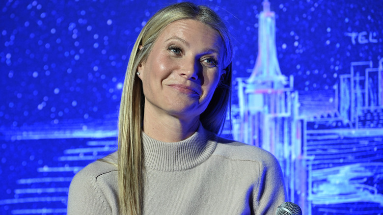 Gwyneth Paltrow shrugs animatedly at a panel discussion in 2020.