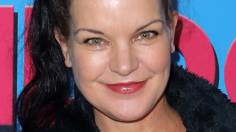 Pauley Perrette wearing ponytail and smiling