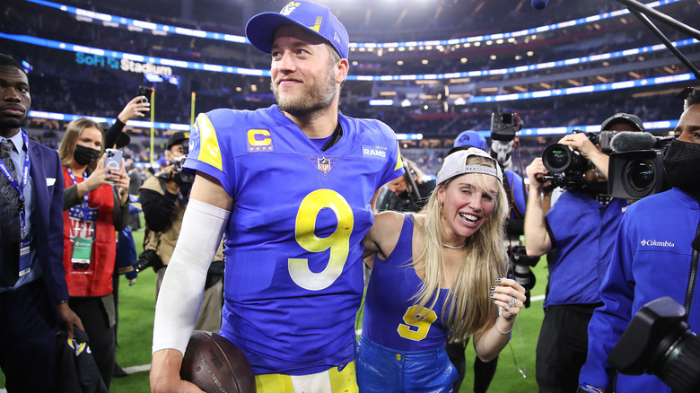 Matthew Stafford and Kelly Stafford on the field 