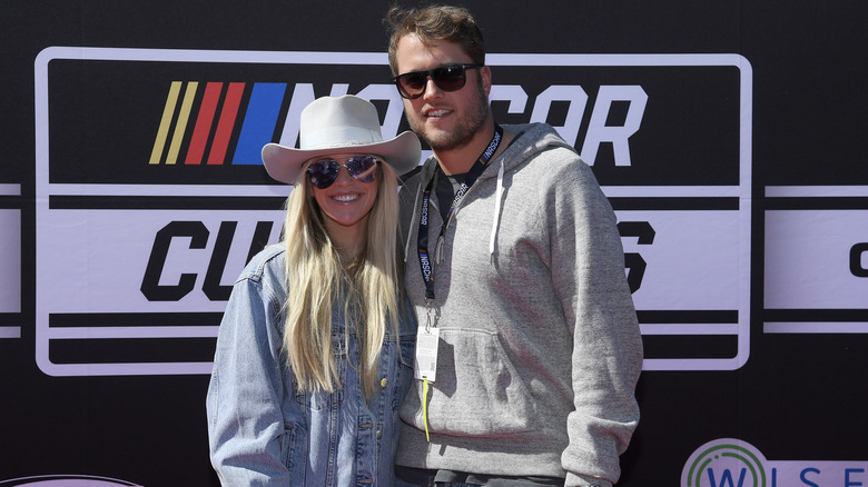 Kelly and Matthew Stafford wearing shades